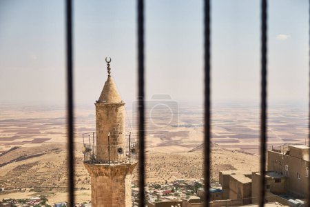 Photo for View of Grand Mosque of Mardin minaret, city roofs and Mesopotamian plain. South-eastern part of Turkey. - Royalty Free Image