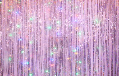 Photo for Photo zone for a Christmas party. Background for photography from lilac tinsel and blurry lights of a luminous garland at a long exposur - Royalty Free Image