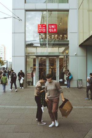Photo for Strasbourg, France - Oct 28, 2022: Customers exits Uniqlo store facade with pedestrians customers - in French city Japanese casual wear designer, manufacturer and retailer. The company is a wholly - Royalty Free Image