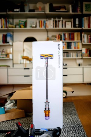 Photo for Paris, France - Jul 16, 2022: Package box package of new cordless vacuum battery operated cleaner by Dyson V12 slim absolute with Vitsoe shelves in background - Royalty Free Image