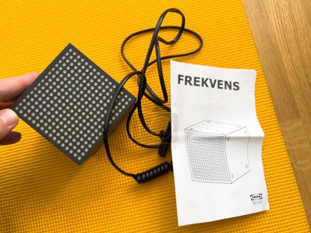 Photo for Amsterdam, Netherlands - Oct 2, 2022: POV male hand unboxing unpacking new Ikea Frekvens limited collection LED multi-use light made in collaboration with teenage engineering - Royalty Free Image