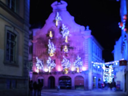Photo for Defocused city Christmas decoration in central Strasbourg with blue lit alsatian house - Royalty Free Image
