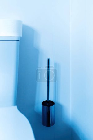 Photo for Modern luxury toilet with stainless steel design toilet brush and holder - blue color cast - Royalty Free Image