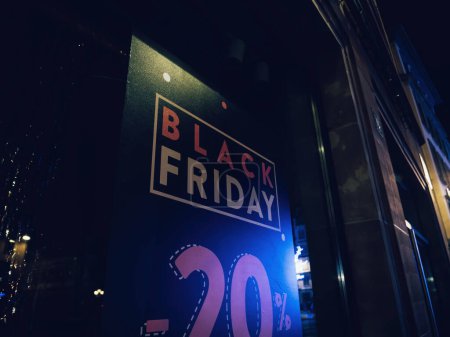 Foto de Low angle view of Black Friday minus 20 percent discount advertising on a store showcase window - Imagen libre de derechos