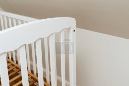 Photo for View from above of new new crib without mattress in nursery room - relocation baby arrival preparation concept - Royalty Free Image