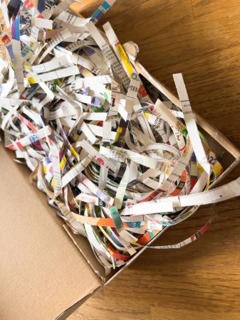Foto de Pile of shredded paper documents newspaper inside cardboard box - Imagen libre de derechos