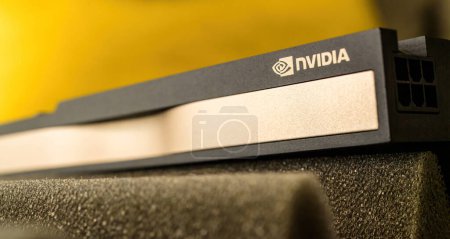 Téléchargez les photos : London, United Kingdom - Aug 5, 2022: Close-up of new NVIDIA logotype insignia on the new RTX A Quadro video GPU - defocused yellow background - en image libre de droit