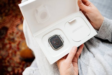 Foto de London, United Kingdom - Sep 28, 2022: POV woman hand holding the package of the new Apple Watch Series Ultra designed for extreme activities like endurance sports - Imagen libre de derechos