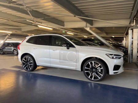 Photo for Basel, Switzerland - Sep 22, 2022: Airport parking with new white Volvo XC60 hybrid car parked next to other cars - Royalty Free Image