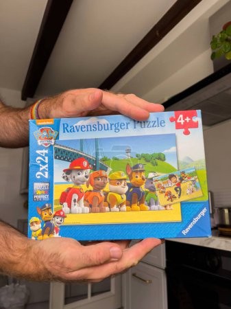 Photo for Paris, France - Sep 13, 2022: Male hand holding Ravensburger Puzzle package for kids - Royalty Free Image