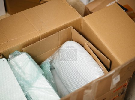 Photo for View from above at large cardboard box with multiple parts of luxury comfortable lounge chairs furniture online purchases - Royalty Free Image