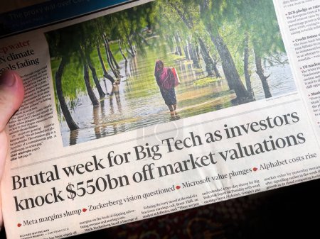 Photo for Paris, France - Oct 29, 2022: Reader holding Financial Times newspaper with headline Brutal week for big tech as investors knock 550 million of market valuations - Royalty Free Image