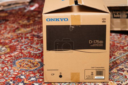 Téléchargez les photos : Paris, France - Dec 16, 2022: Side view of the package new ONKYO D-175 b speaker system cardboard - unboxing unpacking of new hi-fi equipment on living room silk carpet rug - en image libre de droit
