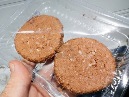 Téléchargez les photos : Close-up of two vegan burgers package plastic protection before cooking - en image libre de droit