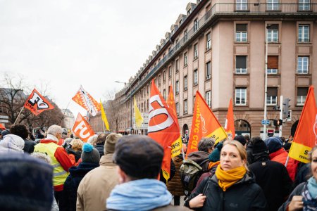 Foto de Strasbourg, France - Jan 19, 2023: View through large crowd at protest against the French governments planned pension reform to push the retirement age from 62 to 64 unions have called for mass - Imagen libre de derechos
