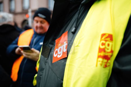 Photo for Strasbourg, France - Jan 19, 2023: Logotype of The General Confederation of Labour French: Confederation Generale du Travail, CGT on male yellow vest at protest against the push of retirement age from - Royalty Free Image