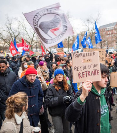 Photo for Strasbourg, France - Jan 19, 2023: French people large crowd at protest against the French governments planned pension reform to push the retirement age from 62 to 64 unions have called for mass - Royalty Free Image