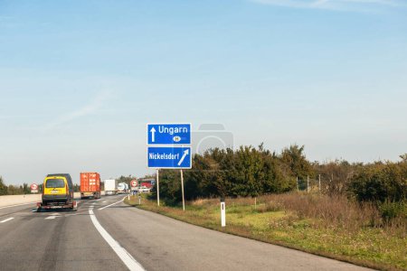 Photo for Austria - Sep 30, 2014: Driver POV at the Ungarn Hungary arrow sign direction on highway with right arrow to the Nickelsdorf, Neusiedl am See state of Burgenland - Royalty Free Image