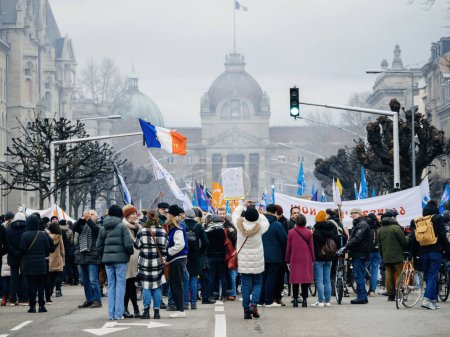Foto de Strasbourg, France - 31 January 2023: Rear view of large crowd with thousands of people - second demonstration against the new pension reform to be presented next month by French Prime Minister - Imagen libre de derechos