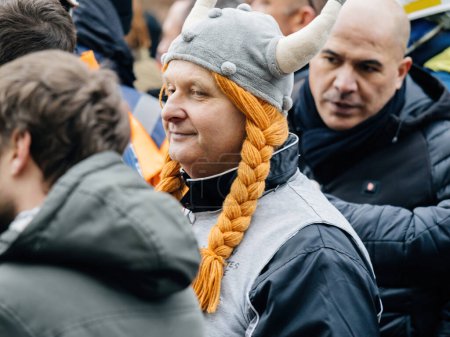 Photo for Strasbourg, France - 31 January 2023: Adult man with Viking hat at second demonstration against the new pension reform to be presented next month by French Prime Minister Elisabeth Borne - Royalty Free Image