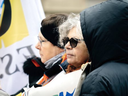 Foto de Strasbourg, France - 31 January 2023: Side view of woman at second demonstration against the new pension reform to be presented next month by French Prime Minister Elisabeth Borne - Imagen libre de derechos