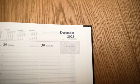 Photo for New 2024 year planner agenda with December 2023 empty month - wooden table background - Royalty Free Image