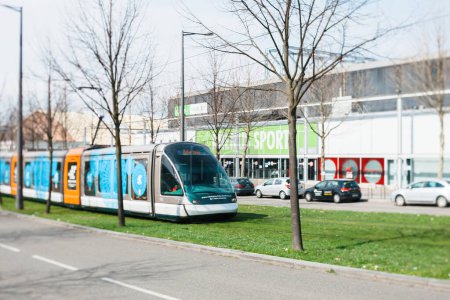 Foto de Strasbourg, France - Mar 28, 2015: Tilt-shift lens view of new tramway operated by CTS in motion near Rhenus Sport arena in Strasbourg - Imagen libre de derechos