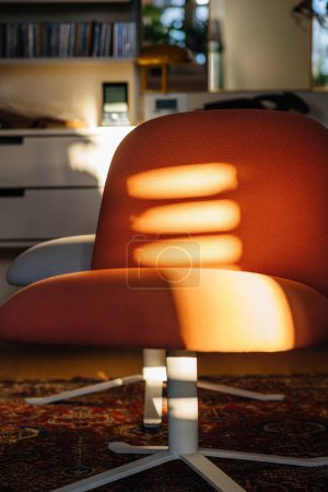 Foto de Rays of light over the red luxury comfortable lounge charis in living room - Imagen libre de derechos