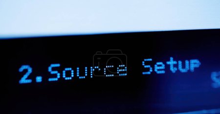 Foto de Source setup text on the LCD display aluminum facade figh-end stereo audio hi-fi receiver - close-up tilt-shift lens used - Imagen libre de derechos