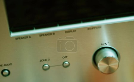 Foto de Input button on aluminum facade figh-end stereo audio hi-fi receiver - close-up tilt-shift lens used - Imagen libre de derechos