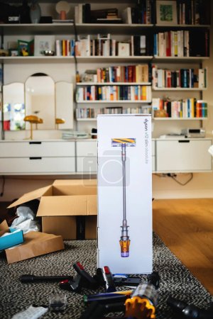 Photo for Paris, France - Jul 16, 2022: Cardboard box package of new cordless vacuum battery operated cleaner by Dyson V12 slim absolute with Vitsoe shelves in background - unbxing new device - Royalty Free Image