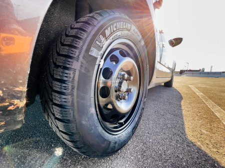 Téléchargez les photos : Clermont-Ferrand, France - Oct 17, 2022: Close-up of new Michelin Alpin 6 Premium touring winter tyre mounted on a new rhim wheel - en image libre de droit