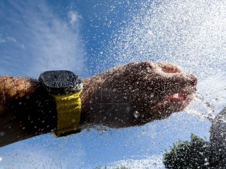 Photo for Paris, France - Sep 23, 2022: male hand water splashes in pool diving swimming with new titanium Apple Watch Ultra designed for extreme activities like endurance sports, elite athletes, trailblazing - Royalty Free Image