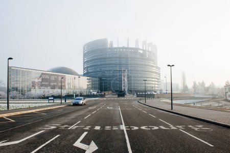 Photo for Strasbourg, France - Jan 6, 2015: The fog lingering in the city reveals a built structure with signs and symbols, marking the roads to guide travelers. - Royalty Free Image