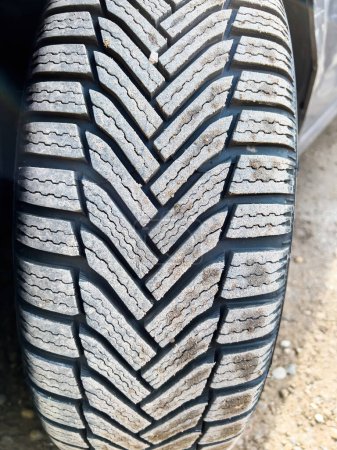 Photo for A close-up of an automotive tire, with its black tread and natural rubber contrasting against the bright bumper. Its a crucial part of any vehicles transportation system. - Royalty Free Image