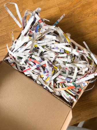 Photo for A close-up of a chaotic heap of shredded newspaper, cardboard and other recycled materials in an overflowing wastepaper basket - Royalty Free Image