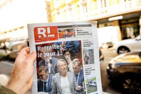 Photo for Paris, France - Mar 20, 2023: POV male hand buy press reading Le republicain Lorrain featuring Elisabeth Borne and votes pension reform wanted by the French government which would raise the retirement - Royalty Free Image