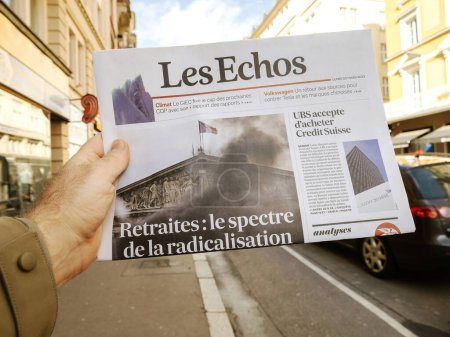Foto de París, Francia - 20 de marzo de 2023: El espectro de la radicalización - retirarse - título del periódico Les Echos leído por los hombres en la mano - Imagen libre de derechos