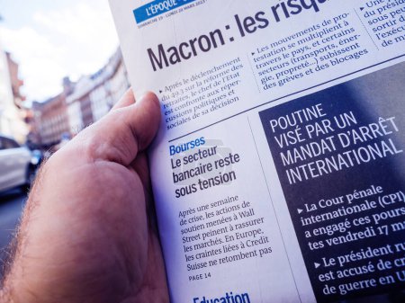 Photo for Paris, France - Mar 20, 2023: Reding in the city French press writing headline: stock market, the banking sector remains under pressure- Wall Street and Credit Suisse situation - Royalty Free Image