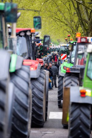 Photo for Strasbourg, France - April 30, 2021: Crowd of farmers next to their tractors at a protest in Strasbourg - Royalty Free Image