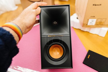 Photo for New York, USA - Apr 18, 2023: Man hand holding new black Klipsch R-50M bookshelf speaker with heavy bass and clear sound for a professional audio experience unpacking unboxing - Royalty Free Image