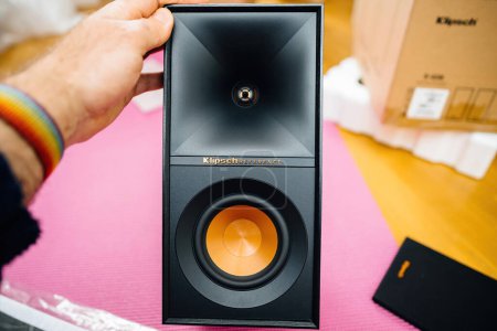 Photo for New York, USA - Apr 18, 2023: Man holding after unboxing a Klipsch R-50M bookshelf speaker with modern design and luxurious wood finish deliver high-end sound with powerful bass for a concert level - Royalty Free Image