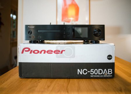 Photo for Frankfurt, Germany - Jan 30, 2023: Unpacking a Pioneer NC-50DAB Network CD Receiver, this modern audio device delivers powerful sound with booming bass and USB capabilities for professional music - Royalty Free Image