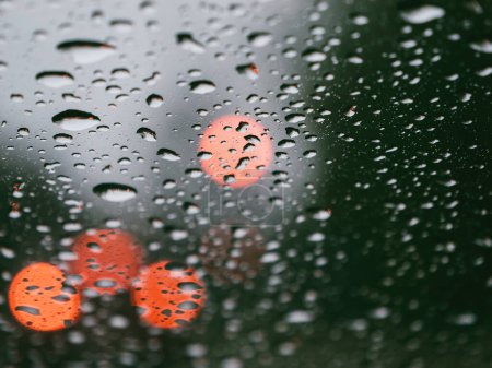 Photo for Rainy season transportation with a full frame window close-up. Water droplets on transparent glass provide a wet background for leafy scenery during monsoon season. - Royalty Free Image