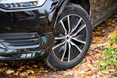Photo for A parked vehicles tire and wheel in an autumn rural setting or urban cityscape. Ideal for transportation-related visuals with a focus on automotive exterior details. - Royalty Free Image