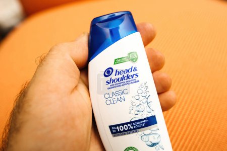 Photo for Paris, France - JUn 3, 2023: A persons hand is holding a bottle of classic Head and Shoulders shampoo. - Royalty Free Image