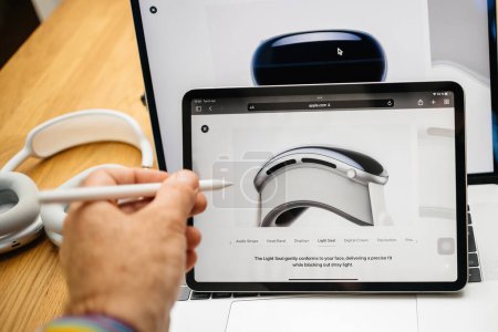 Photo for Paris, France - Jun 6, 2023: Hand scrolling over Light Seal for new Apple Vision Pro mixed reality XR headset. Priced 3,499 USD - future of computing - Royalty Free Image