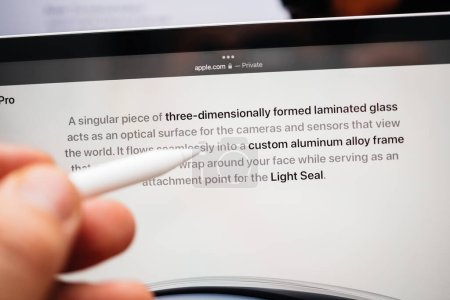 Photo for Paris, France - Jun 6, 2023: Hand with pencil scorlling the webpage of Apple on iPad Pro showcasing Apple Vision Pro mixed reality XR headset. Priced 3,499 USD - future of computing - Royalty Free Image