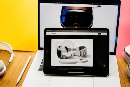 Photo for Paris, France - Jun 6, 2023: Creative room table with webpage of Apple on iPad Pro showcasing battery for Apple Vision Pro mixed reality XR headset. Priced 3,499 USD - future of computing - Royalty Free Image