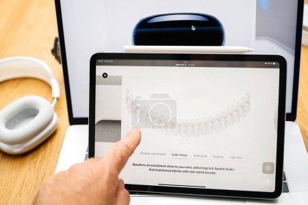 Photo for Paris, France - Jun 6, 2023: Hand pointing to Audio Straps on the webpage of Apple on iPad Pro showcasing Apple Vision Pro mixed reality XR headset. Priced 3,499 USD - future of computing - Royalty Free Image